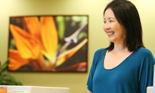 Smiling woman by colorful painting Smiling woman by colorful painting