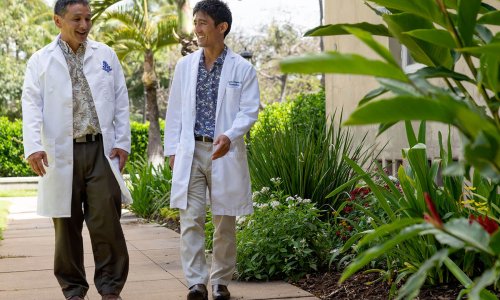two neurologists walking outside two neurologists walking outside
