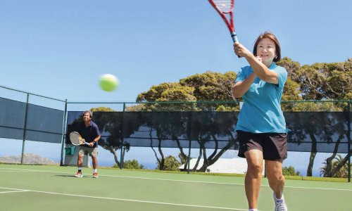 Woman hitting a tennis ball Woman hitting a tennis ball