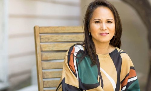 Middle-aged woman sitting in a chair Middle-aged woman sitting in a chair